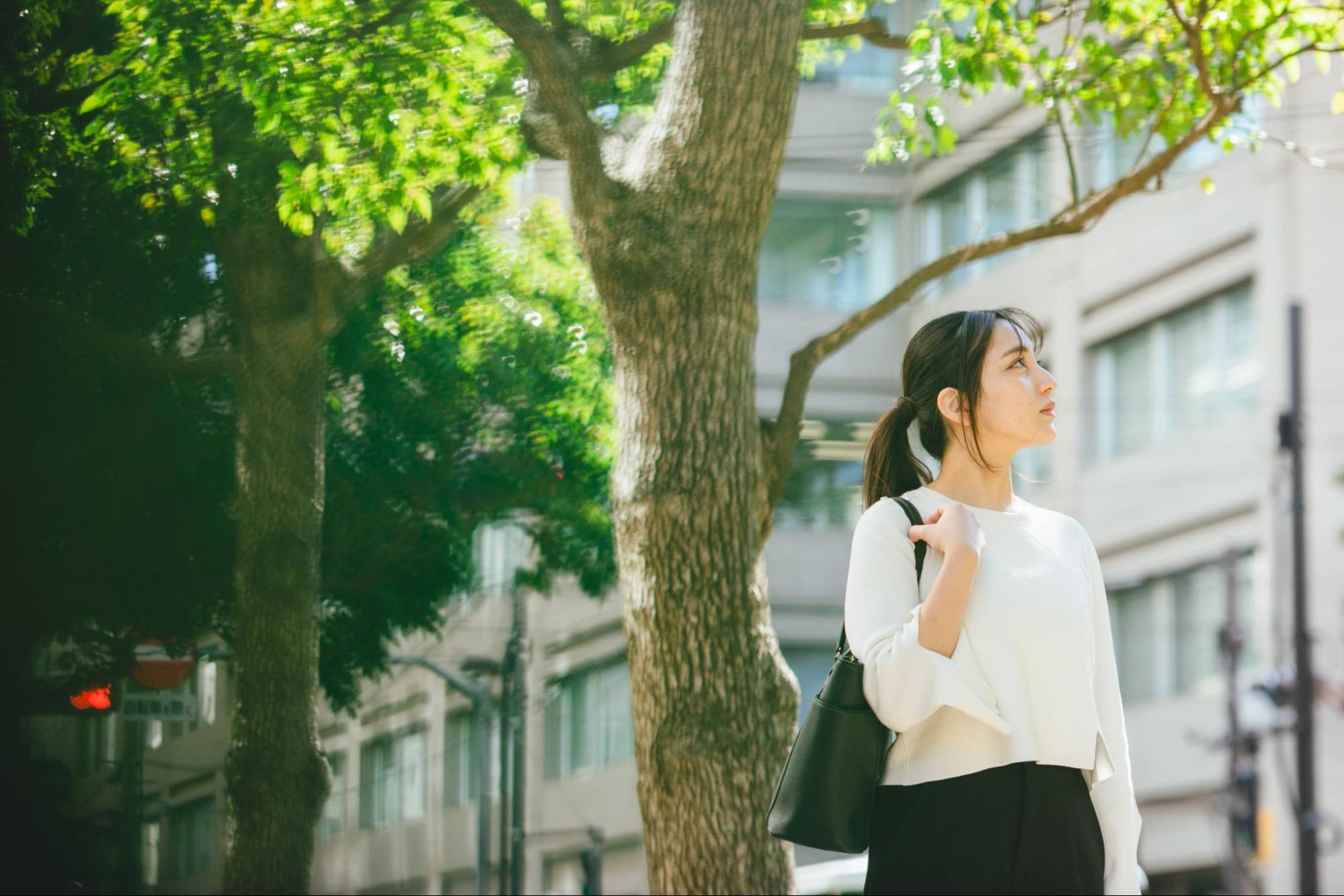 街路樹の下に立つ就活生